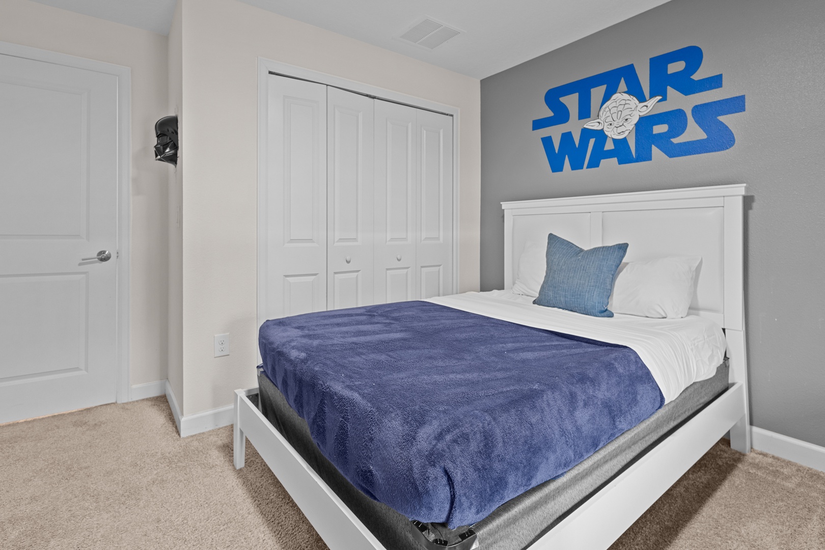 Your little Jedi will love drifting off to sleep in this themed bedroom with cozy blue bedding and Star Wars wall art.