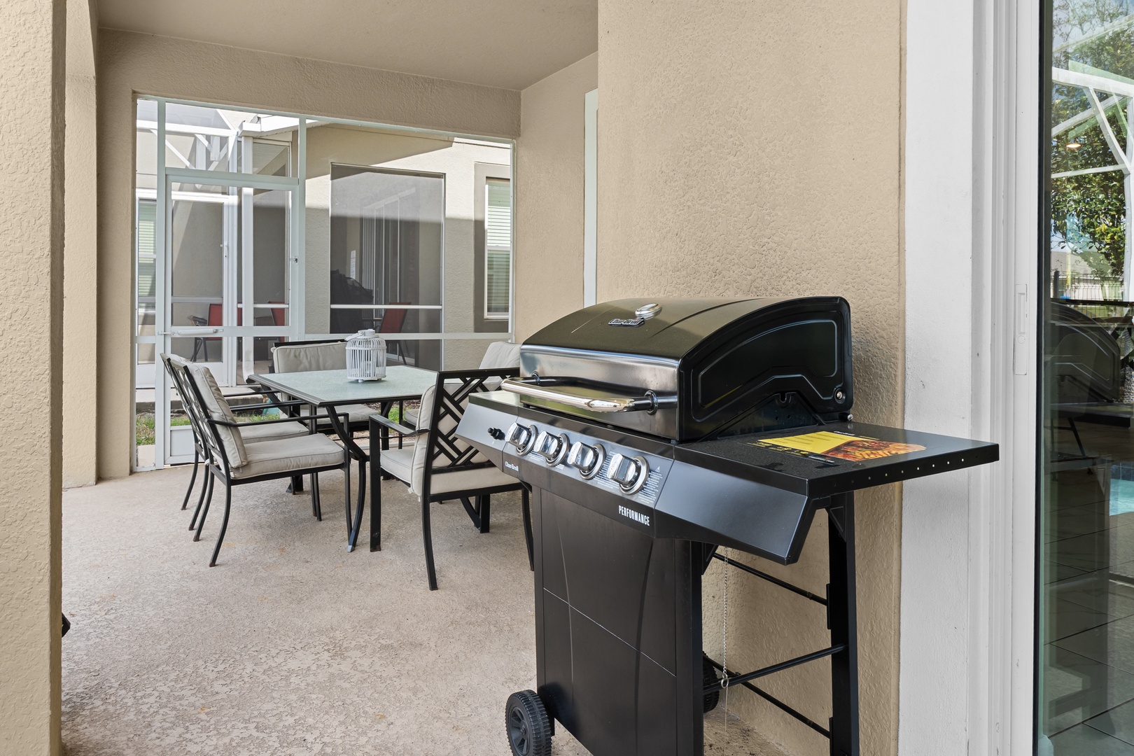 Your private patio features a premium gas grill and dining table, perfect for outdoor meals under your covered terrace.
