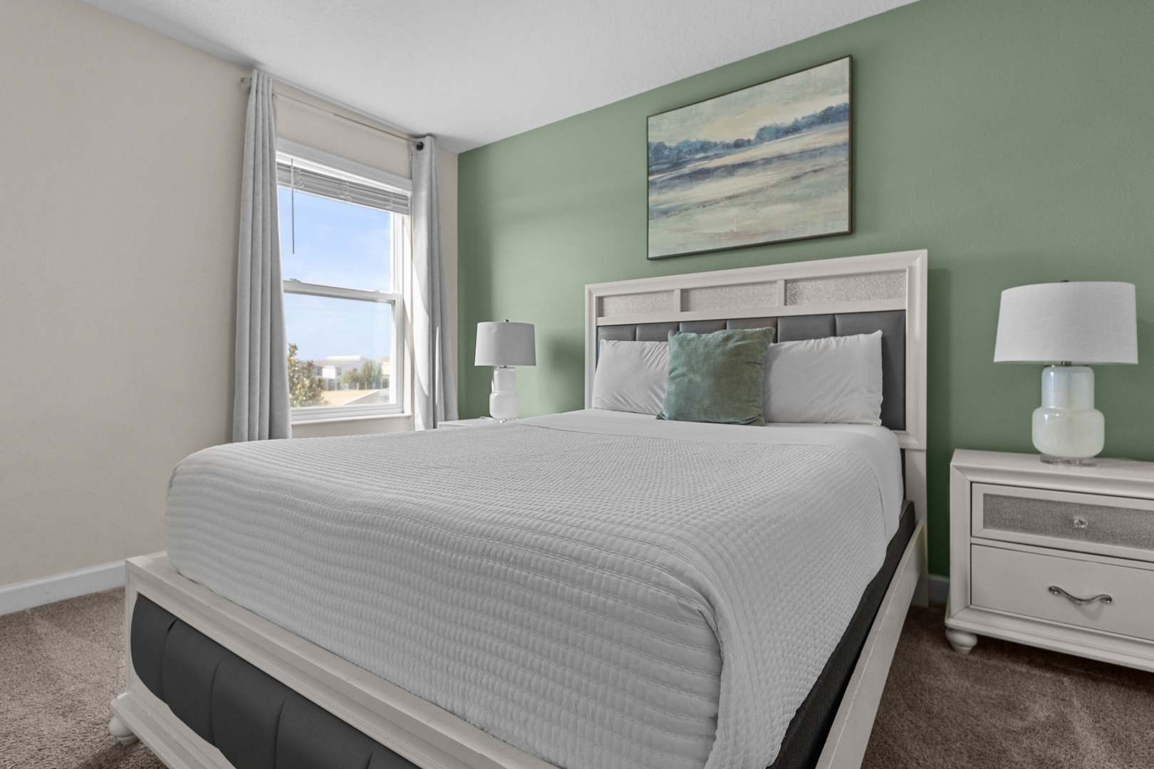 Drift off peacefully in your serene bedroom, where calming green tones and cozy bedding create the perfect retreat for restful nights.