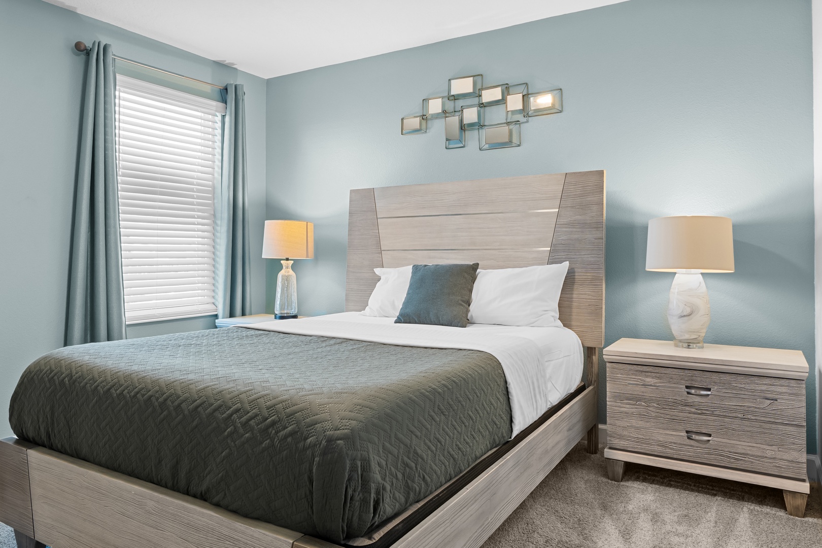 Drift into peaceful sleep in your stylish bedroom, where soft blue walls create a calming sanctuary complete with modern furnishings and warm bedside lighting.