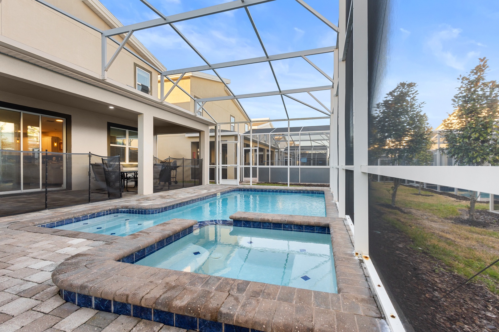 Your private screened pool oasis awaits, with sparkling waters and spa ready for relaxation.