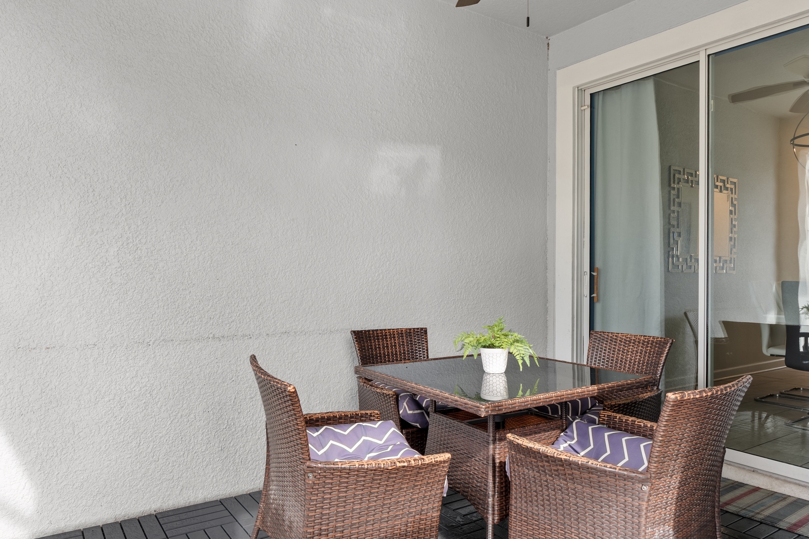 Unwind on your private terrace with comfortable wicker seating and stylish glass table, perfect for morning coffee or evening relaxation.
