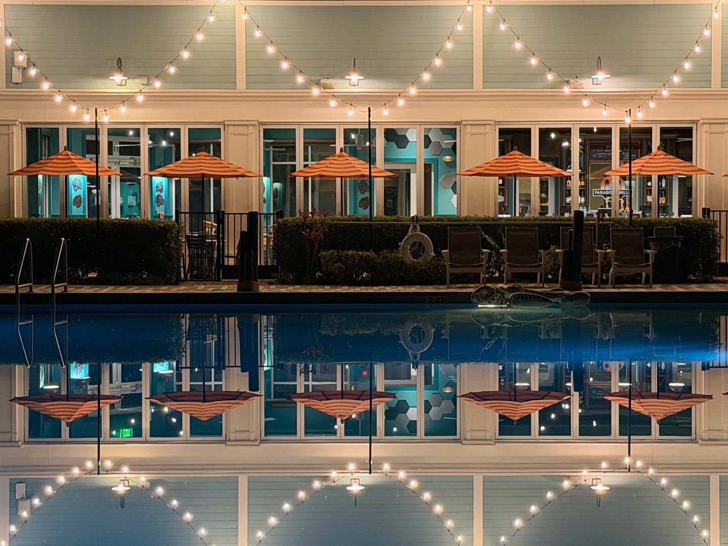 Unwind by your sparkling pool as twinkling lights create magical ambiance overhead, reflecting beautifully in the water below.