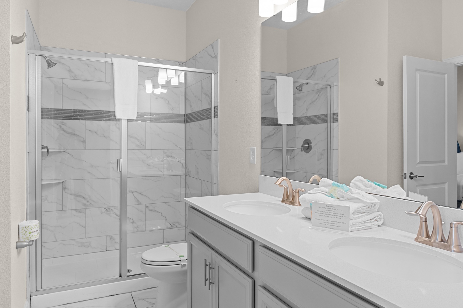 Your elegant master bathroom features marble-inspired tile, dual vanities, and a spacious glass shower for ultimate comfort and relaxation.