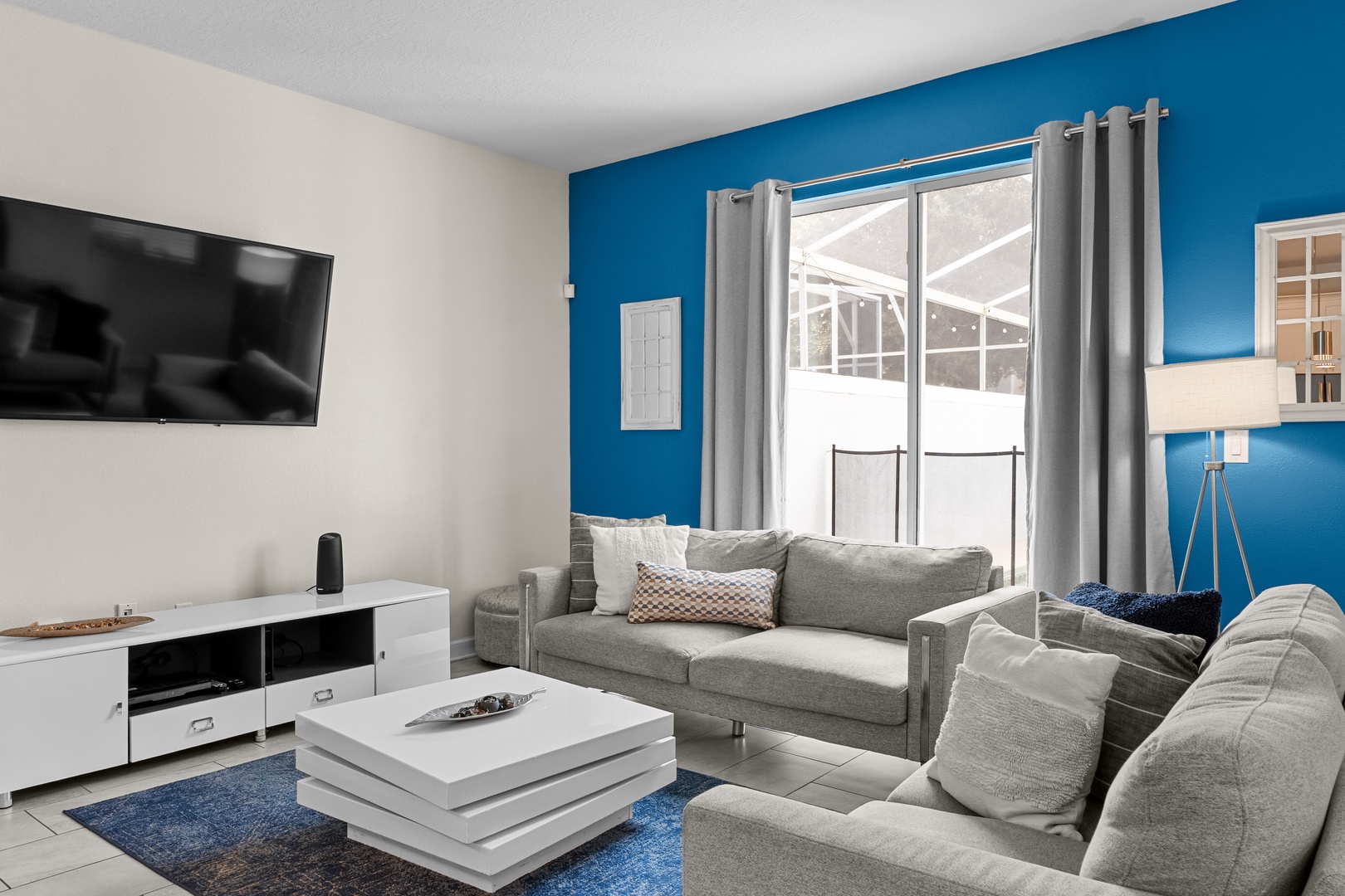 Sink into plush gray sofas while your favorite shows play on the large flat-screen TV in this stylish living space.