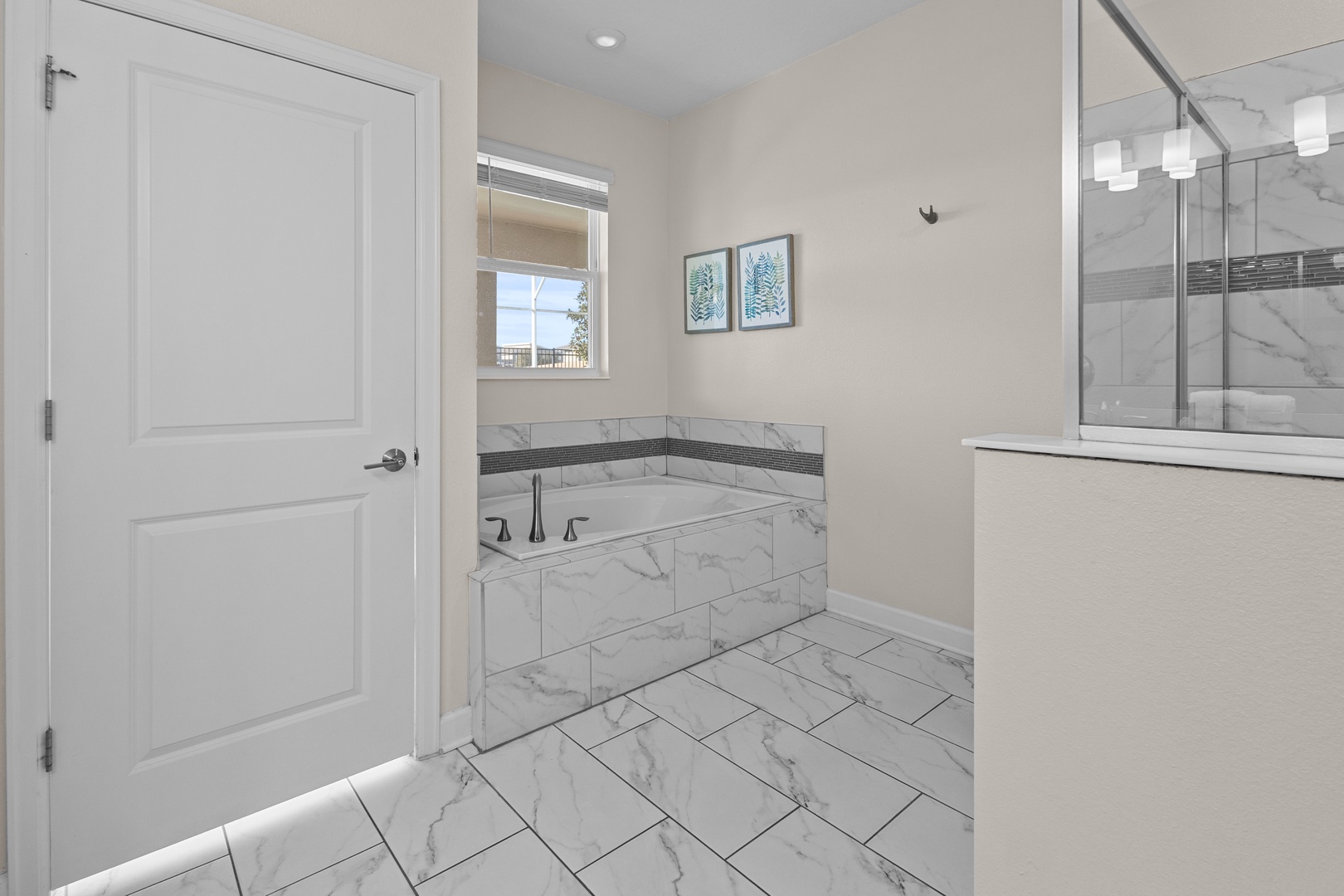 Sink into marble luxury in your private spa bathroom, complete with deep soaking tub and elegant finishes.