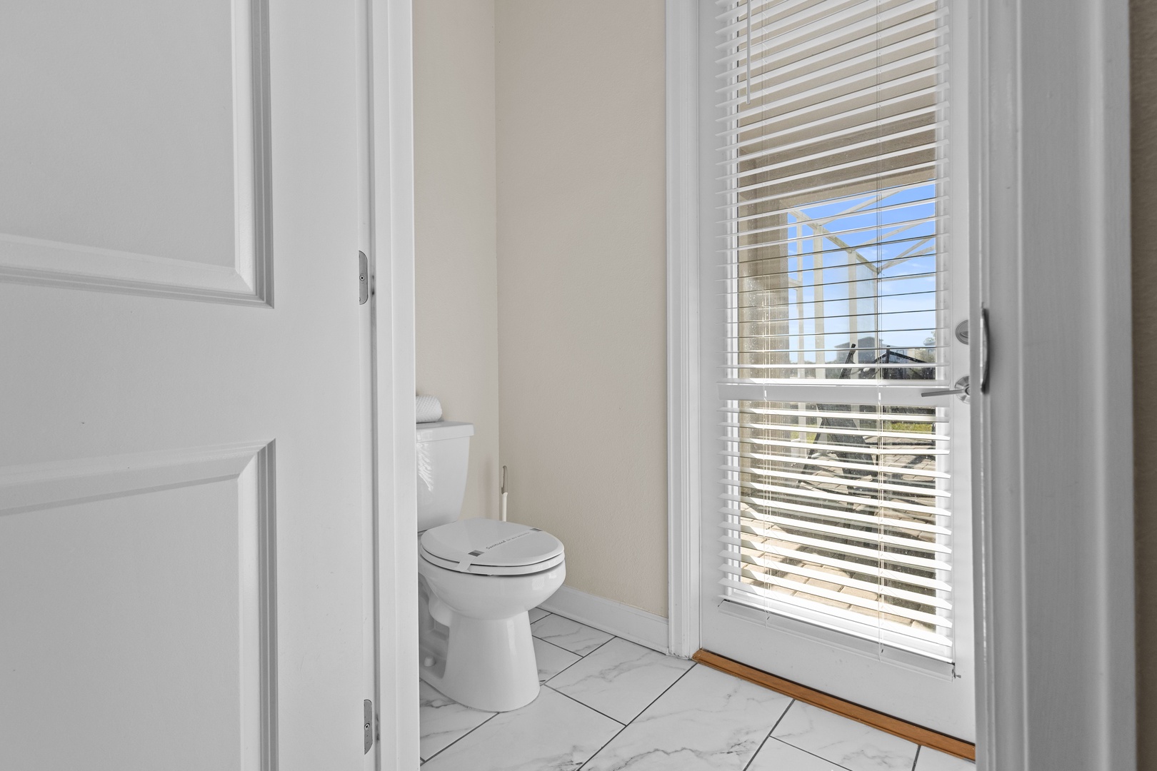 Your bright, clean bathroom features modern fixtures and a window that fills the space with natural light.