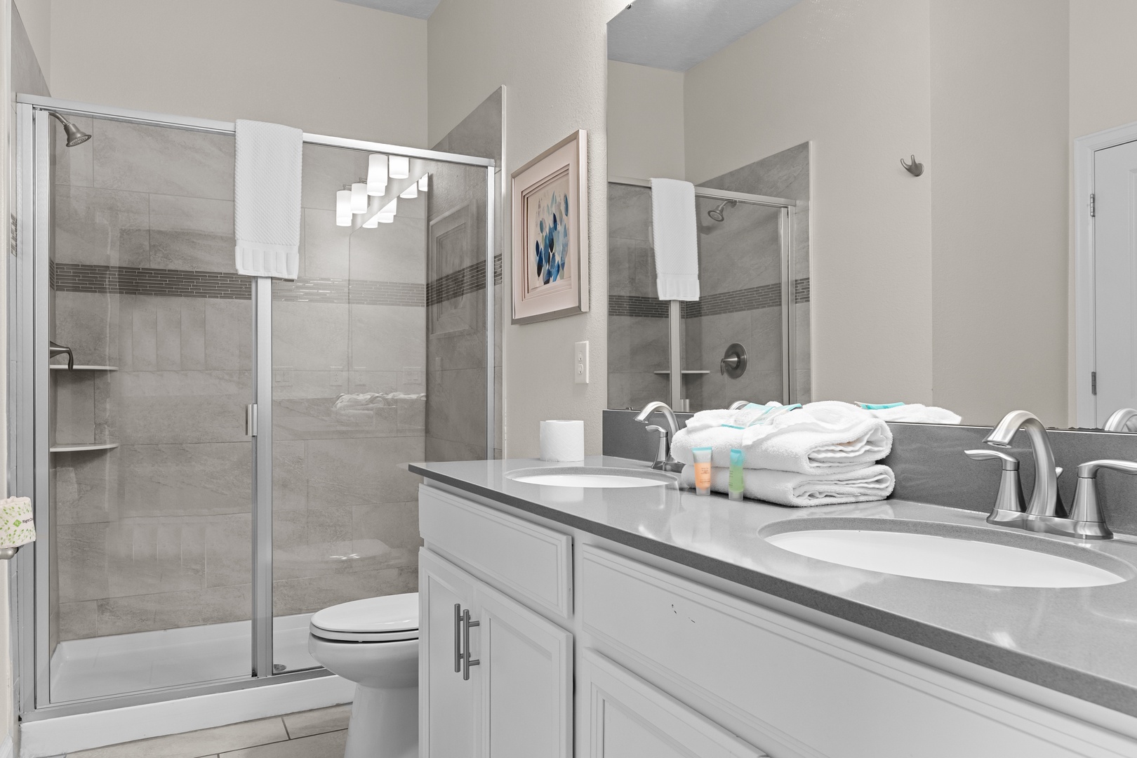 Step into your spa-like bathroom featuring dual sinks, spacious shower, and plush towels—your perfect morning retreat.