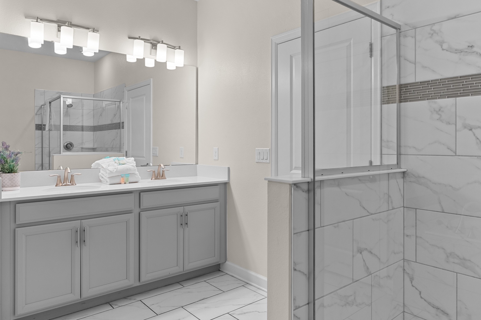 Step into your spa-like bathroom with elegant marble finishes, spacious glass shower, and luxurious double vanity for ultimate relaxation.