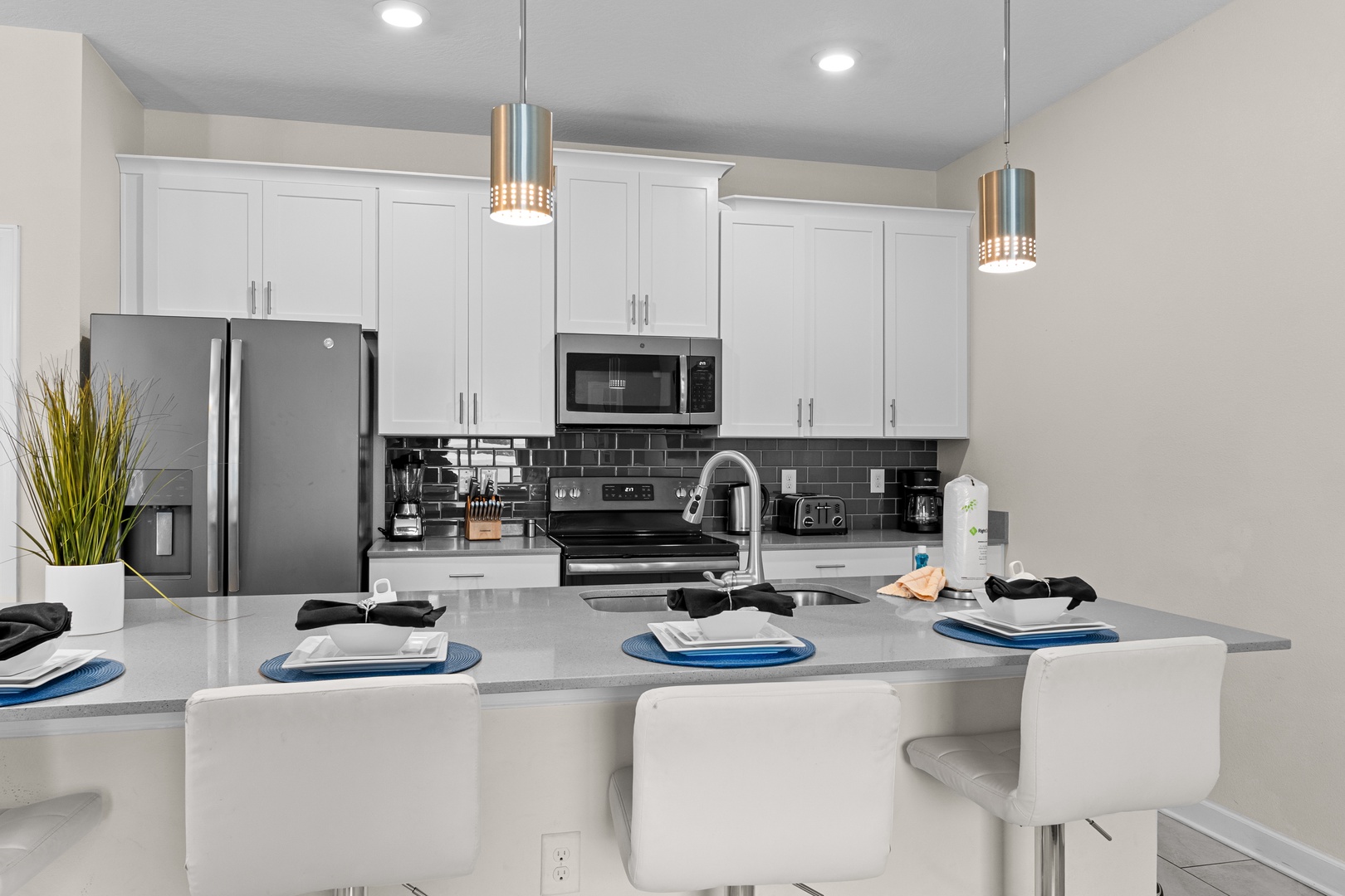 Cook memorable meals in your modern kitchen, featuring sleek granite countertops, stainless steel appliances, and stylish pendant lighting perfect for gathering.