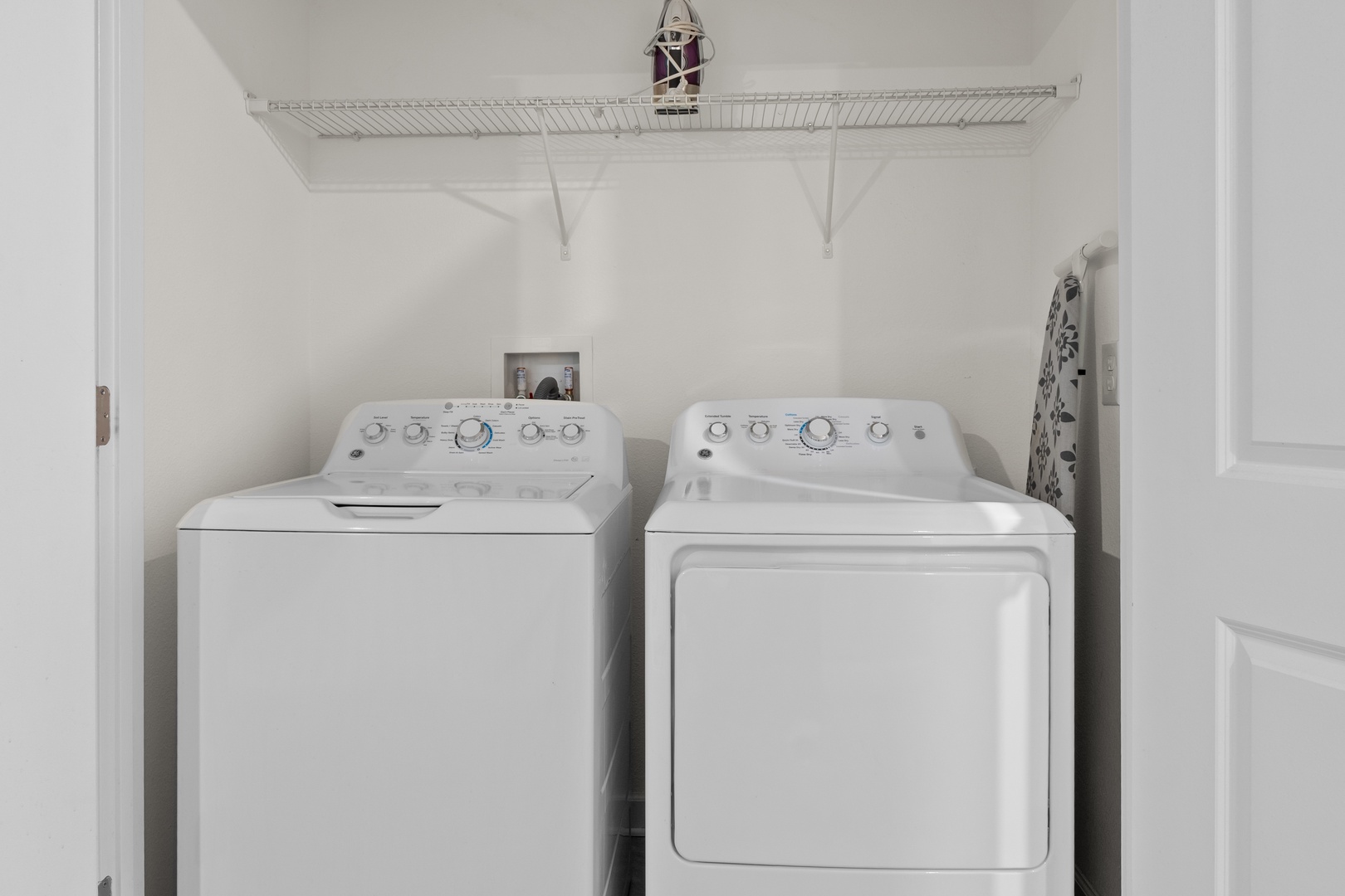 Your dedicated laundry space makes extended stays effortless with full-sized washer and dryer, plus organized storage above.