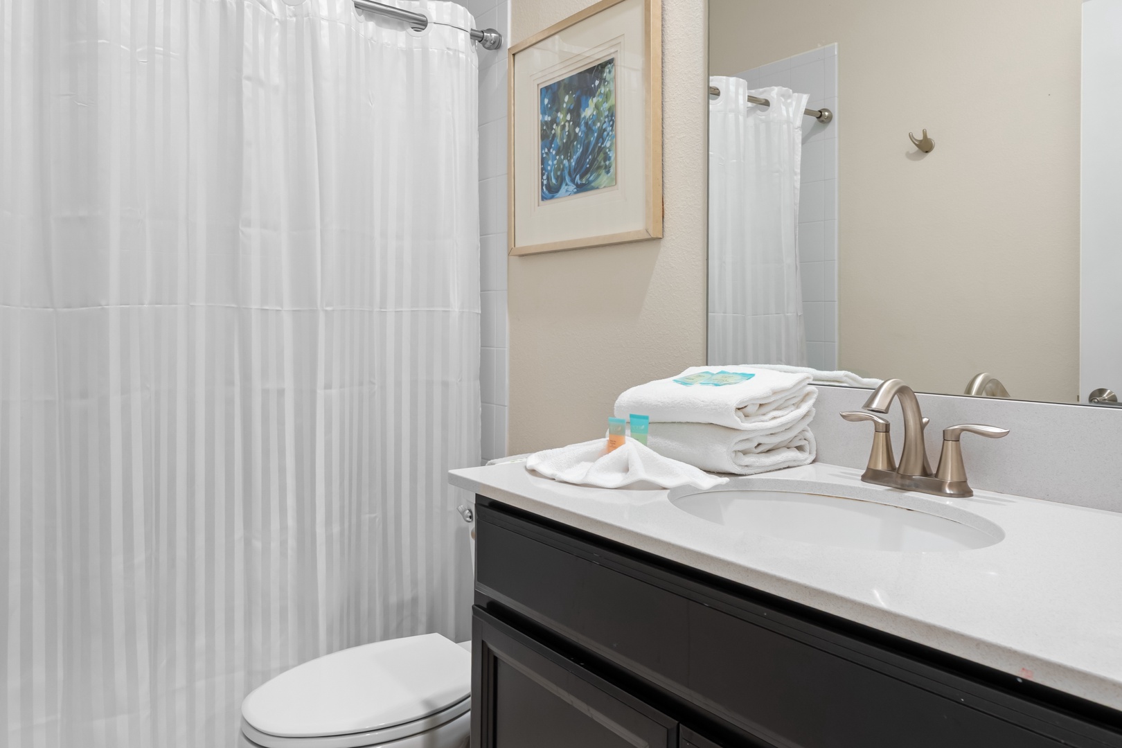 Step into your private bathroom with fresh towels, premium amenities, and a relaxing shower waiting for your arrival.