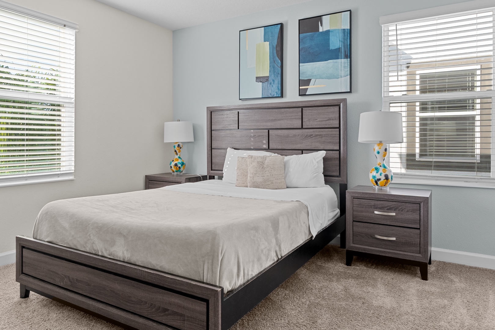 Sink into plush bedding in your tranquil bedroom, where modern furnishings and artistic touches create the perfect retreat for restful nights.