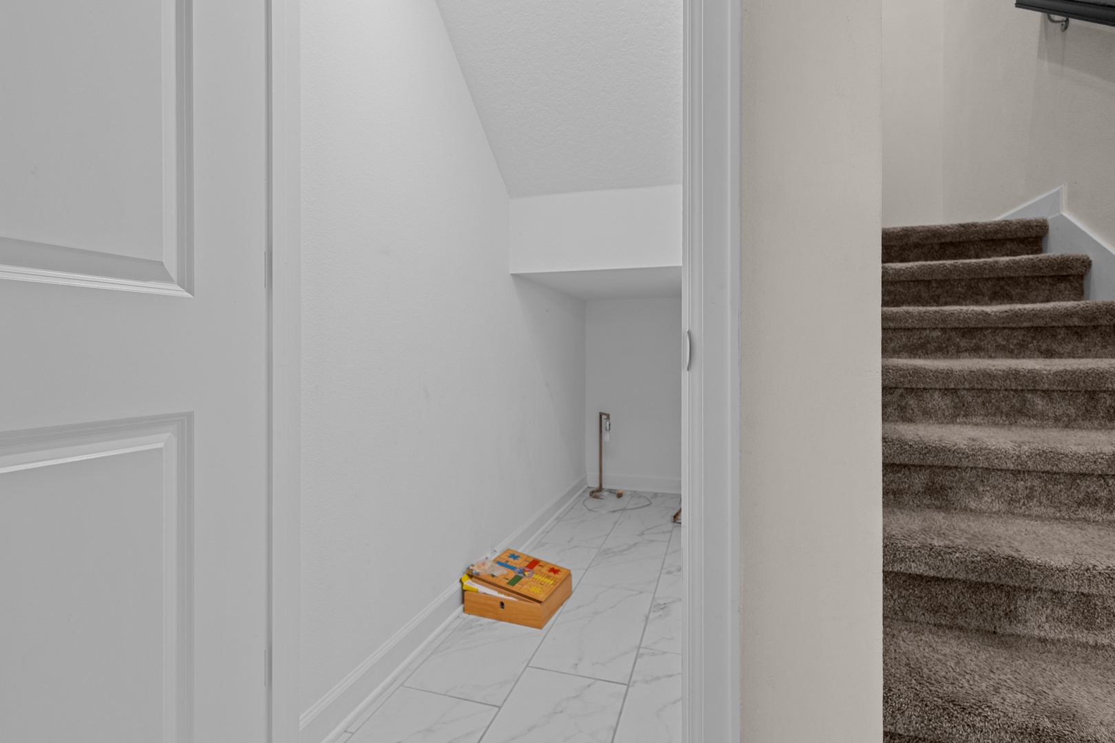 Your spacious under-stair storage offers convenient organization space, with easy tile flooring for effortless cleaning and maintenance.