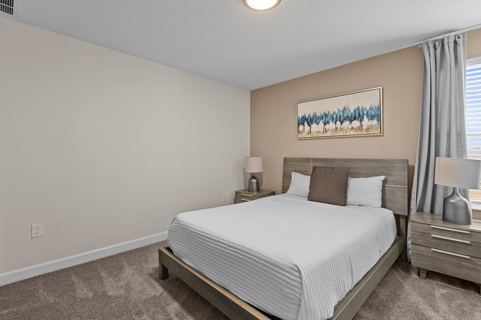Sink into crisp white linens in your peaceful bedroom retreat, complete with modern furnishings and thoughtful touches for ultimate relaxation.