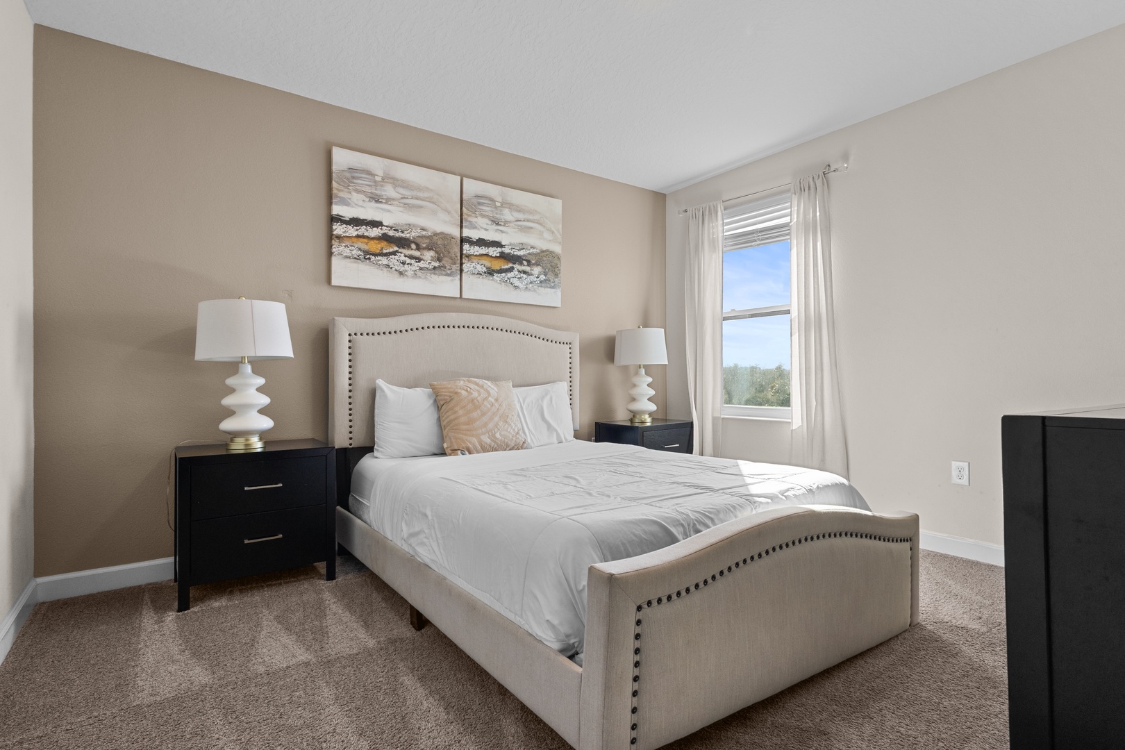 Sink into this comfortable bed with soft linens and enjoy serene views from your peaceful retreat.