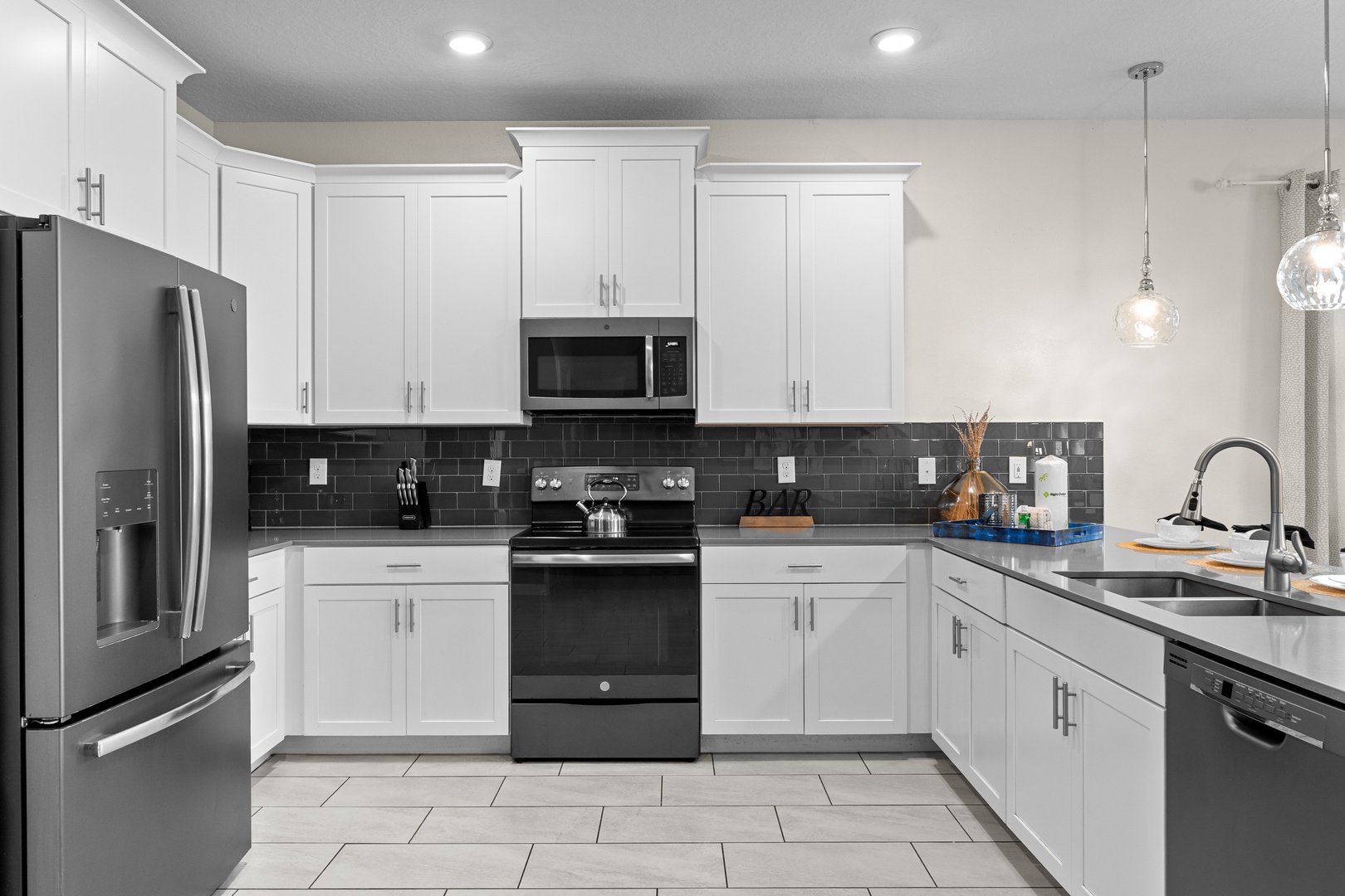 Your fully equipped kitchen awaits with modern appliances and sleek countertops for home-cooked meals during your stay.
