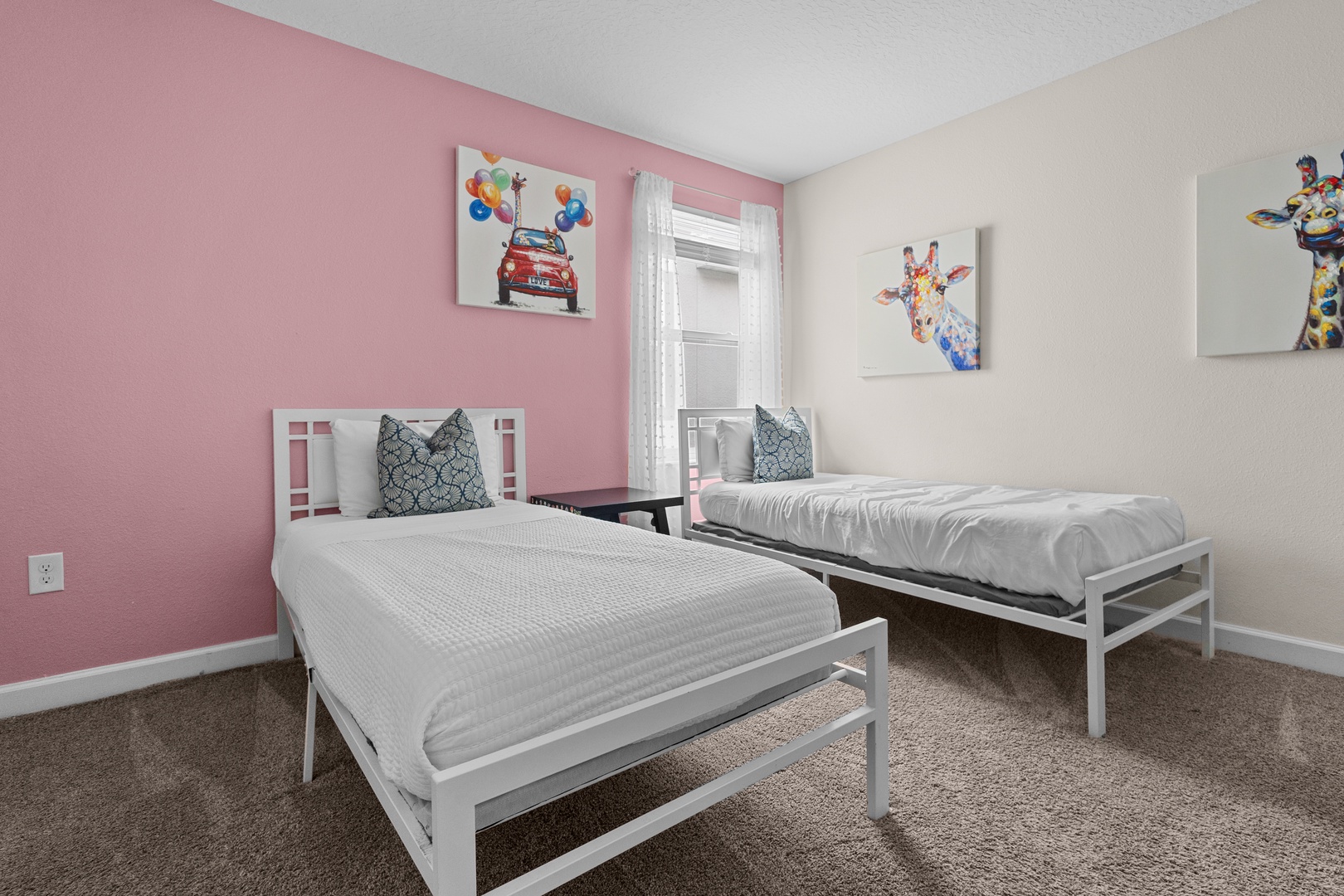 Your kids will love this cheerful twin bedroom with playful animal art and cozy white beds perfect for restful nights.