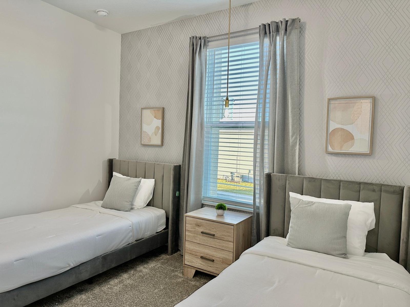 Settle into your twin beds with stylish headboards and crisp linens, perfect for sharing space while maintaining personal comfort.