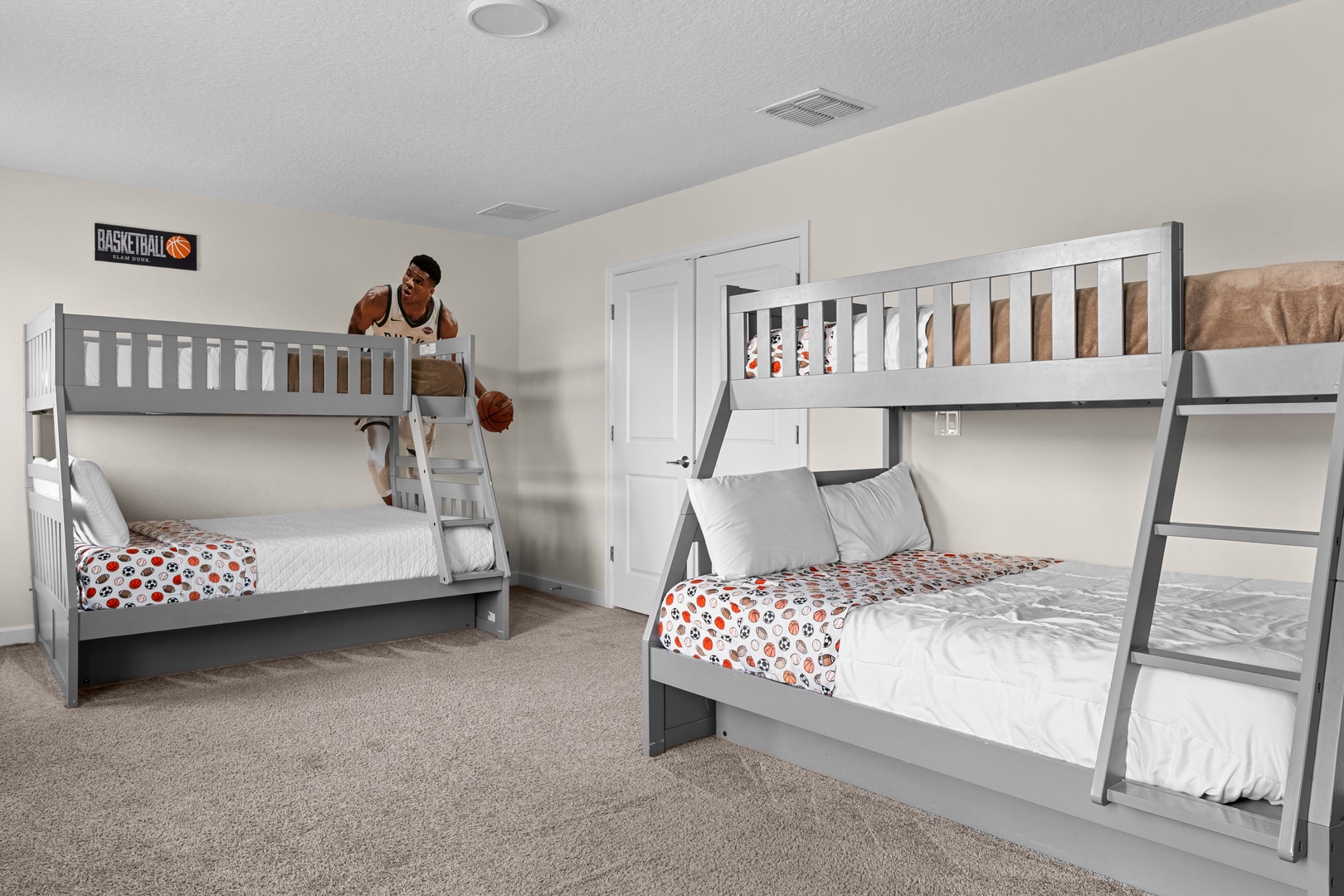 Your kids will love this spacious bedroom with sturdy gray bunk beds, complete with sports-themed decor and plenty of room for fun and rest.