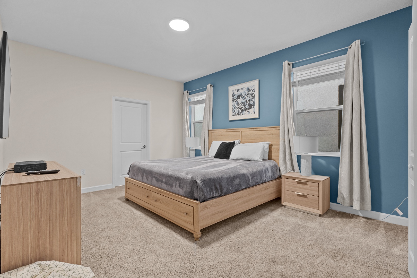 Drift off to sleep in this peaceful bedroom with its calming blue accent wall and comfortable queen bed.