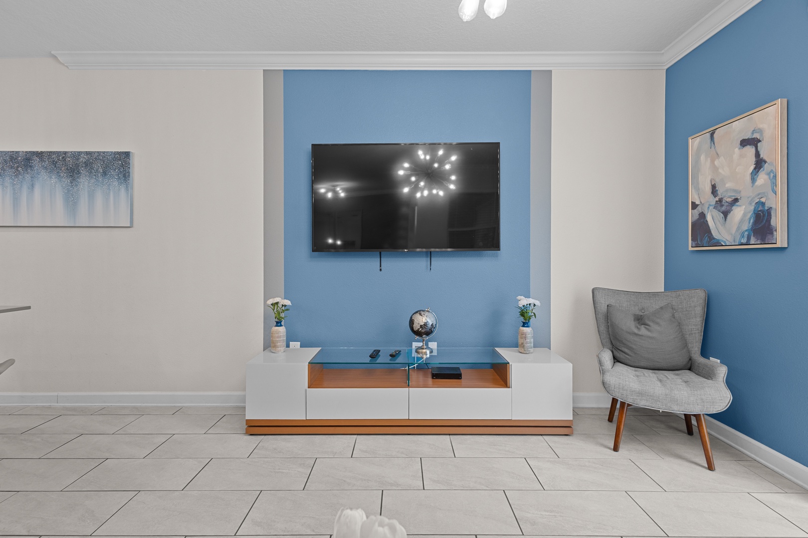 Unwind in your stylish living space featuring a sleek TV setup and comfortable seating, perfectly designed for relaxing evenings together.