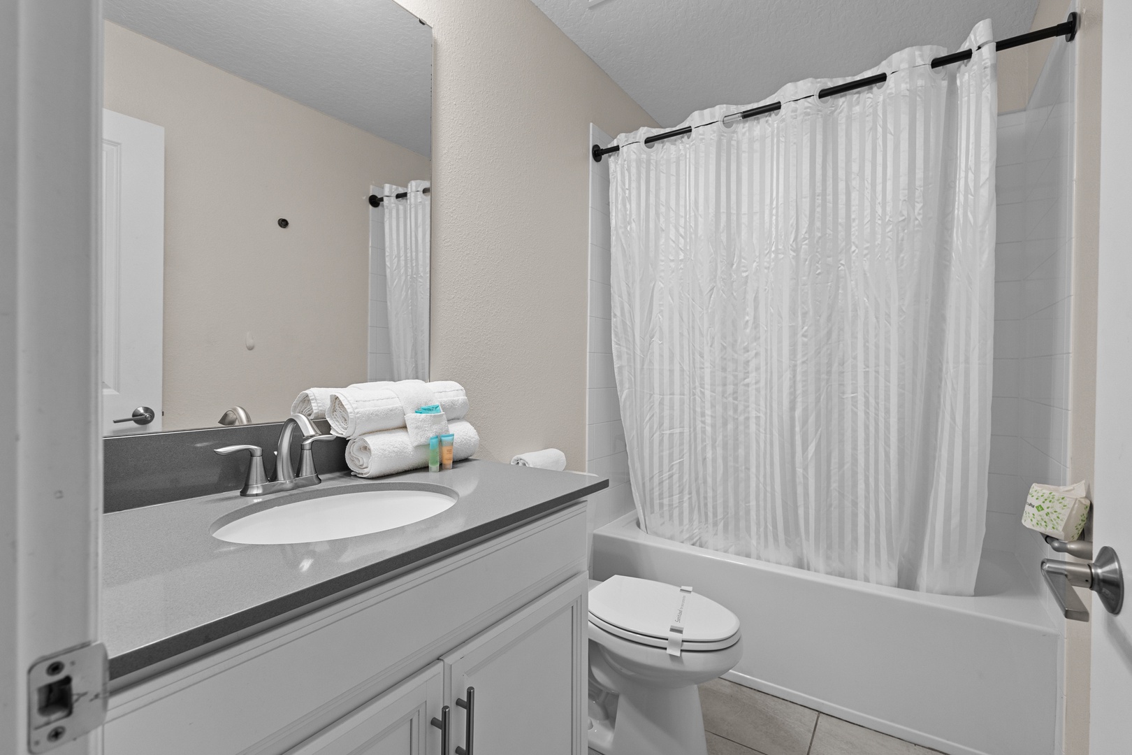 Refresh in your private bathroom with fresh towels, modern fixtures, and a relaxing tub-shower combo.