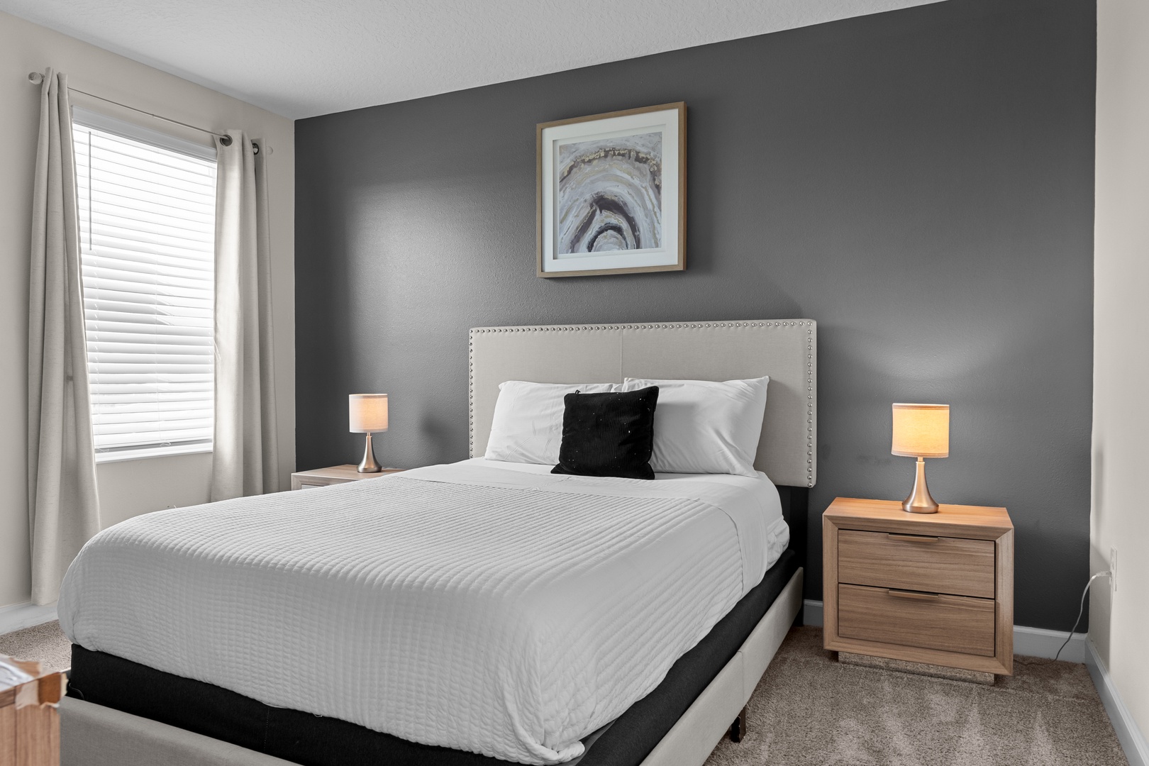 Your peaceful bedroom features a plush queen bed with hotel-quality linens, elegant lighting, and stylish artwork for restful nights.