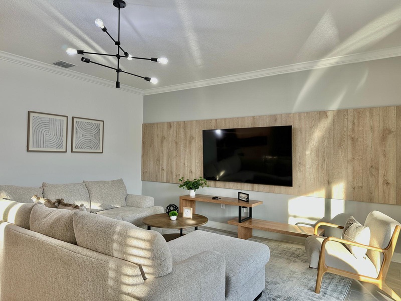 Relax in this bright, modern living room where sleek furniture meets warm wood accents, perfect for unwinding after your adventures.