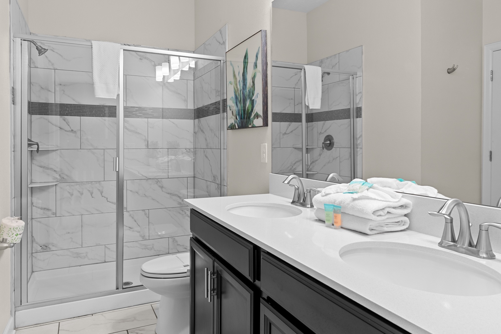 Step into your marble-inspired oasis where gleaming fixtures and plush towels await your refreshing shower experience.