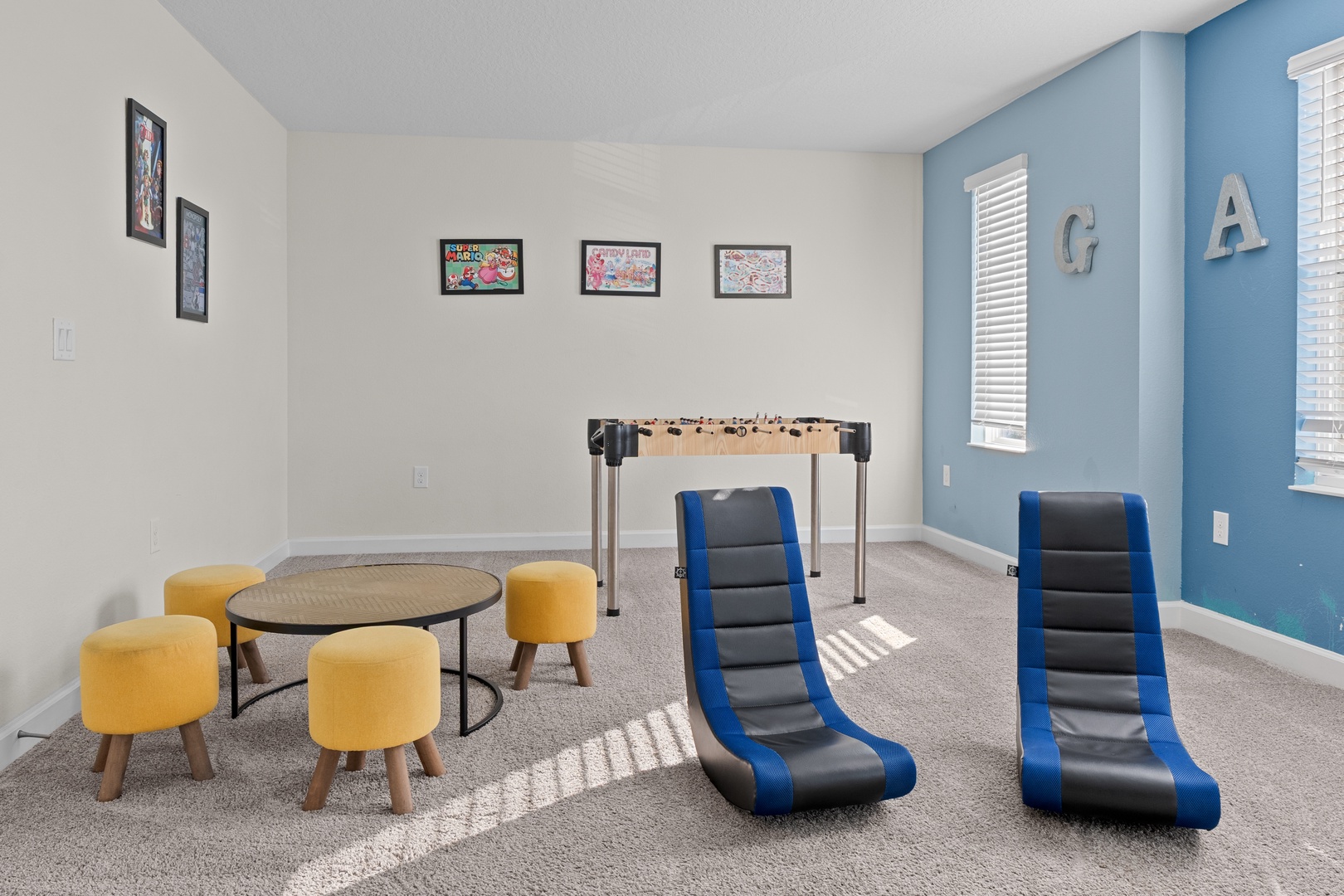 Your family game room awaits with foosball, gaming chairs, and cozy seating for endless entertainment and bonding moments.