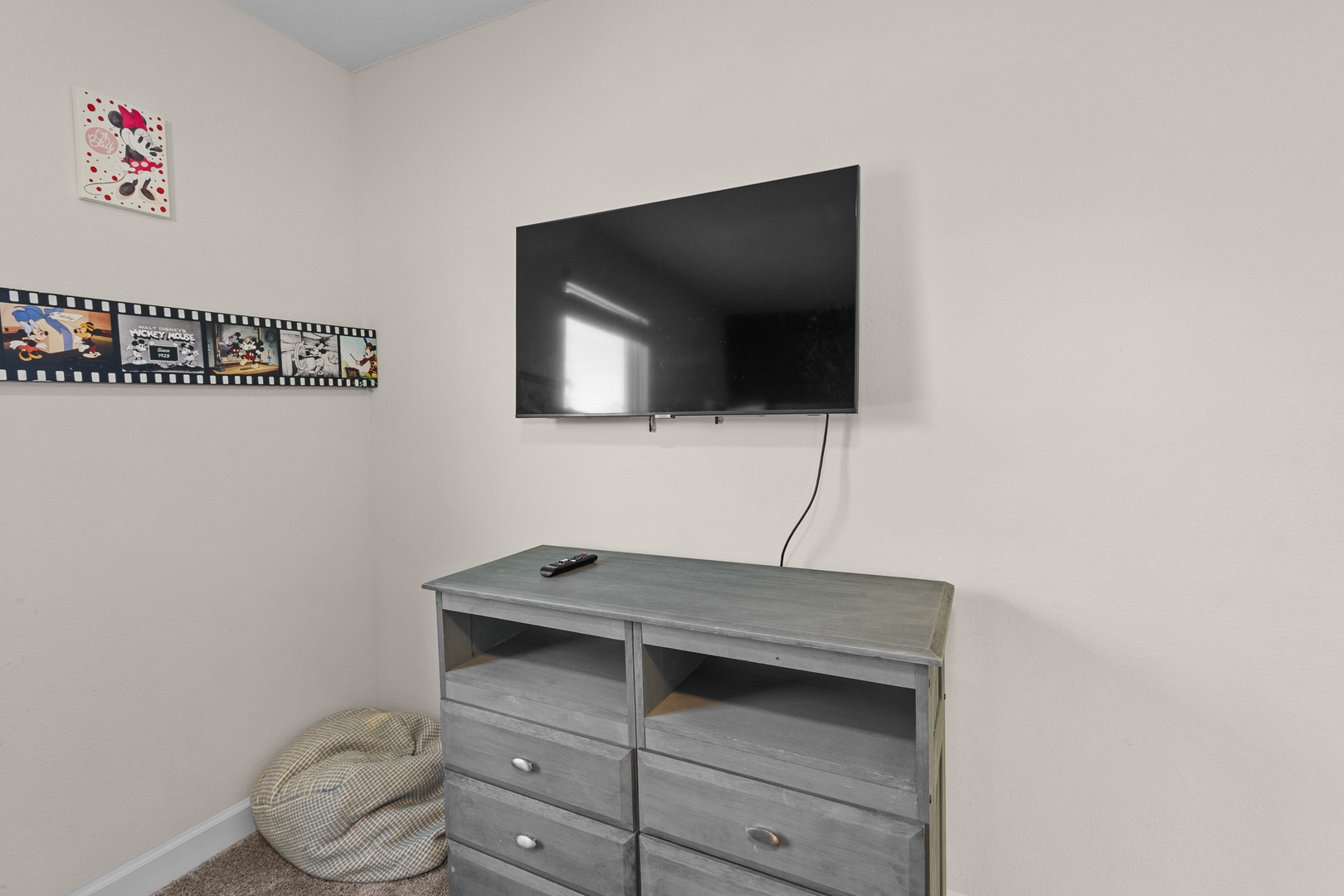 Unwind in your cozy entertainment corner with a large TV for movie nights and a comfy bean bag for ultimate relaxation.