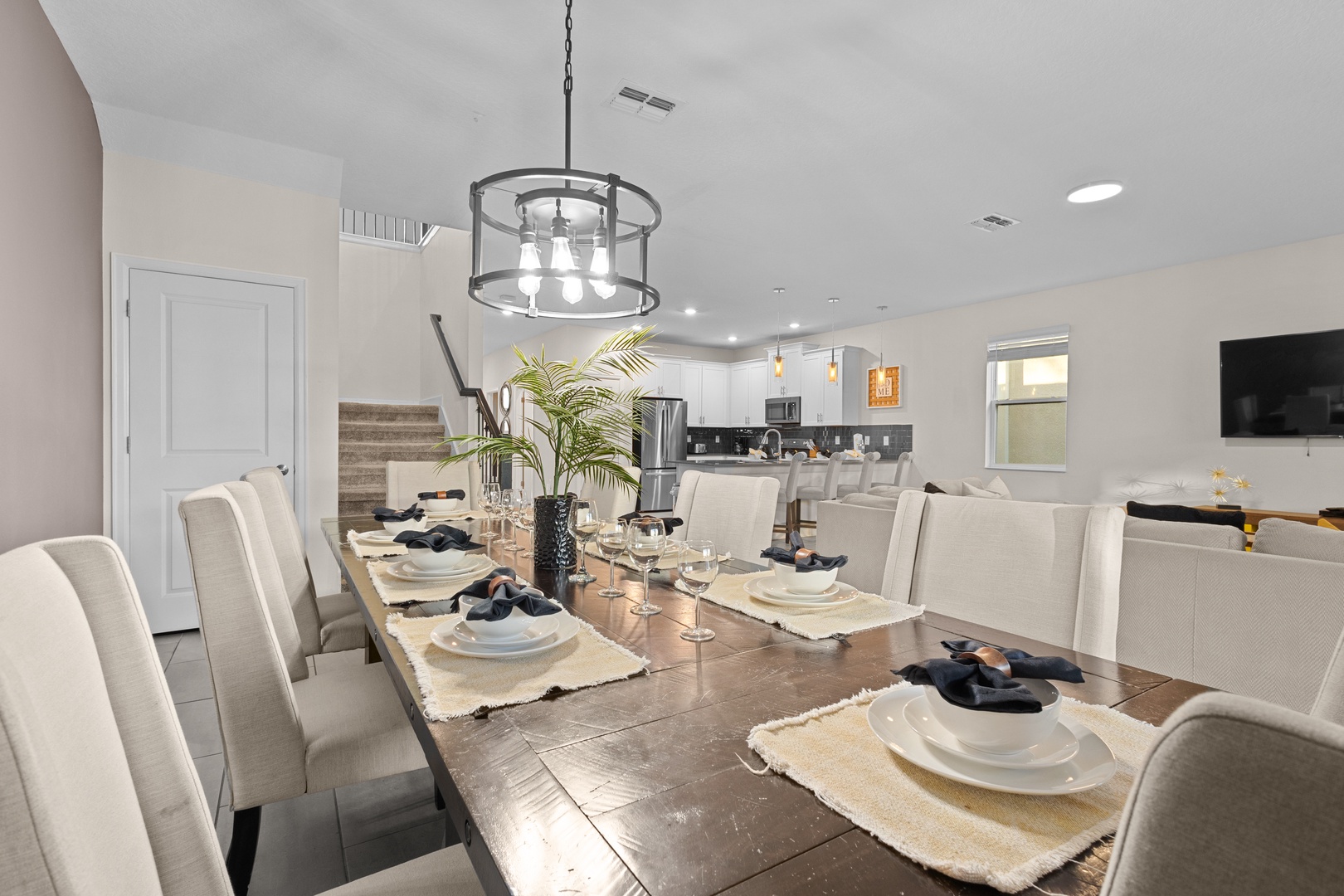Gather around this elegant dining table where memorable meals await. The open-plan design flows into your fully equipped kitchen.