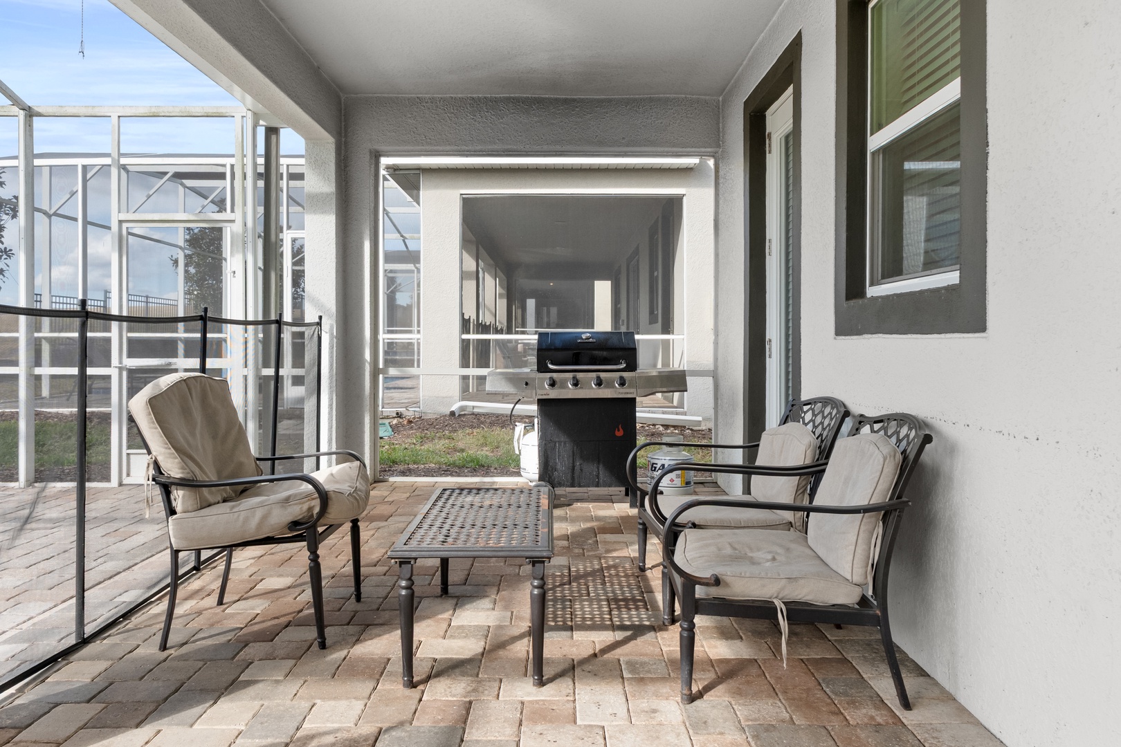 Your private covered patio offers comfortable seating and a convenient BBQ grill for perfect outdoor dining moments.