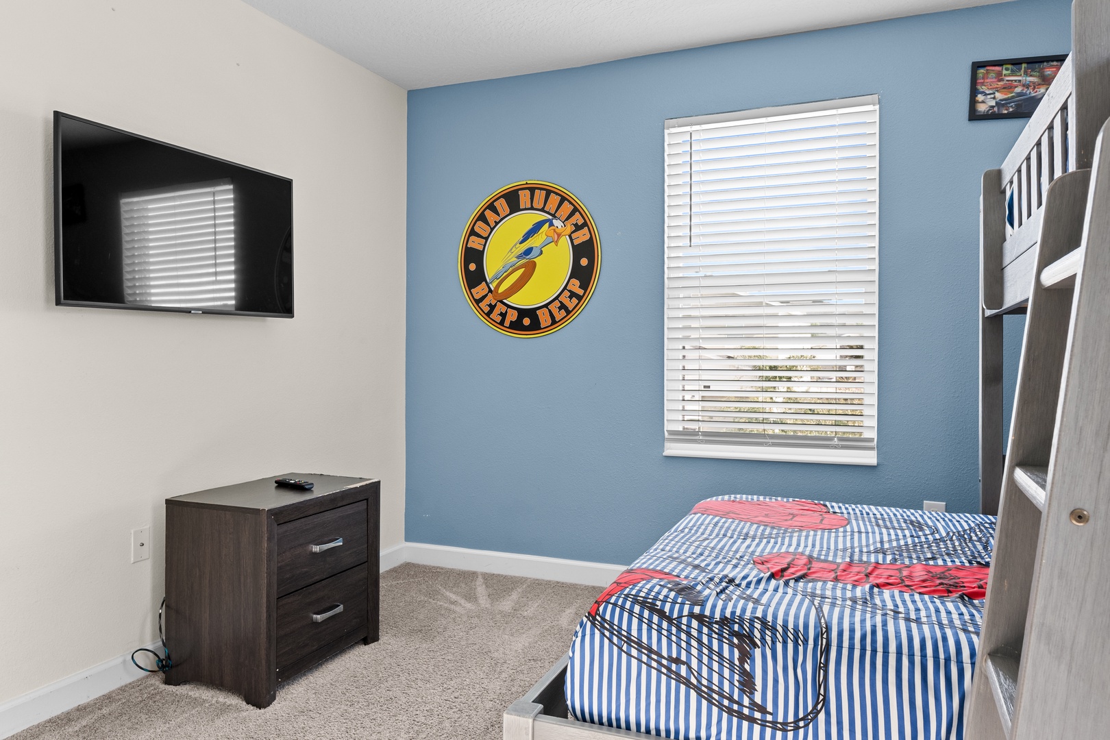 Your kids will love this fun bedroom with a bunk bed, colorful decor, and their own TV for movie nights after adventure-filled days.