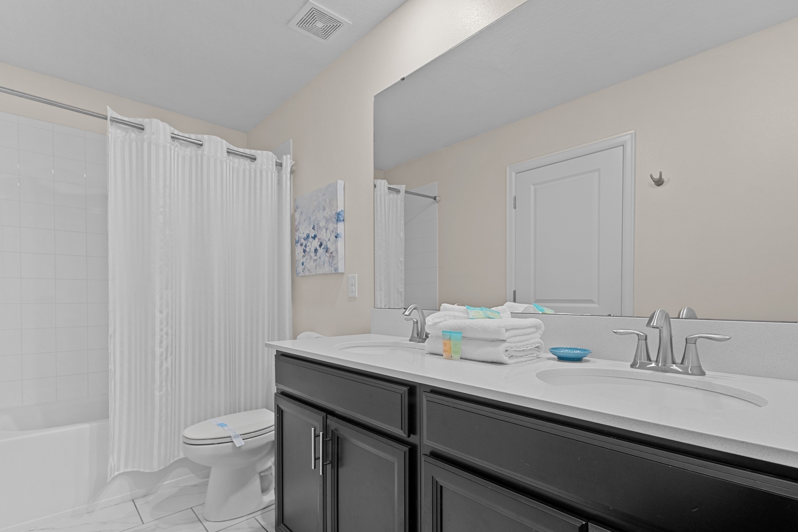 Step into your spacious bathroom with dual sinks, perfect for getting ready together, plus a relaxing tub-shower combo for unwinding.