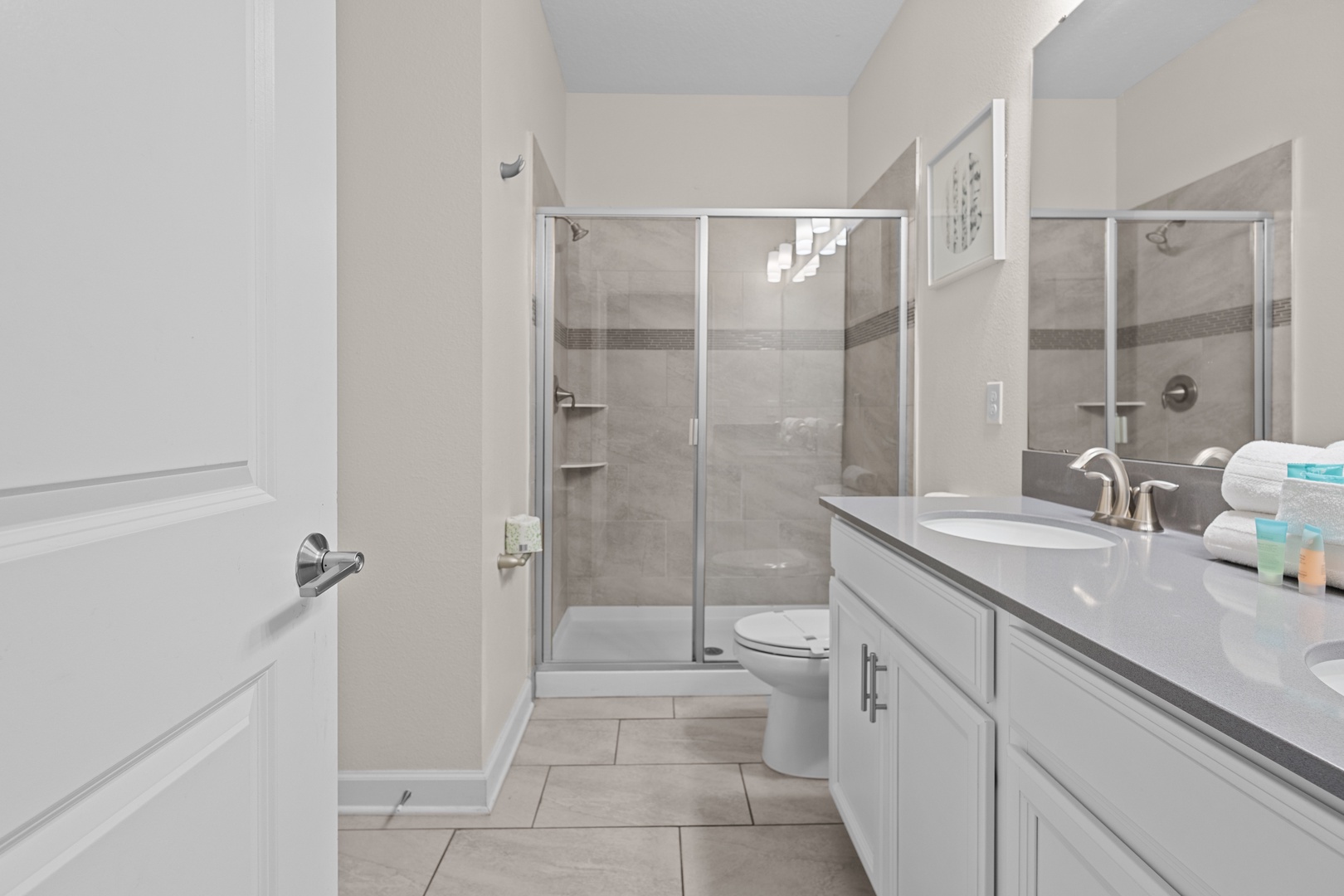 Refresh in your spacious master bathroom featuring a sleek walk-in shower, soaking tub, and pristine quartz countertops with premium amenities.