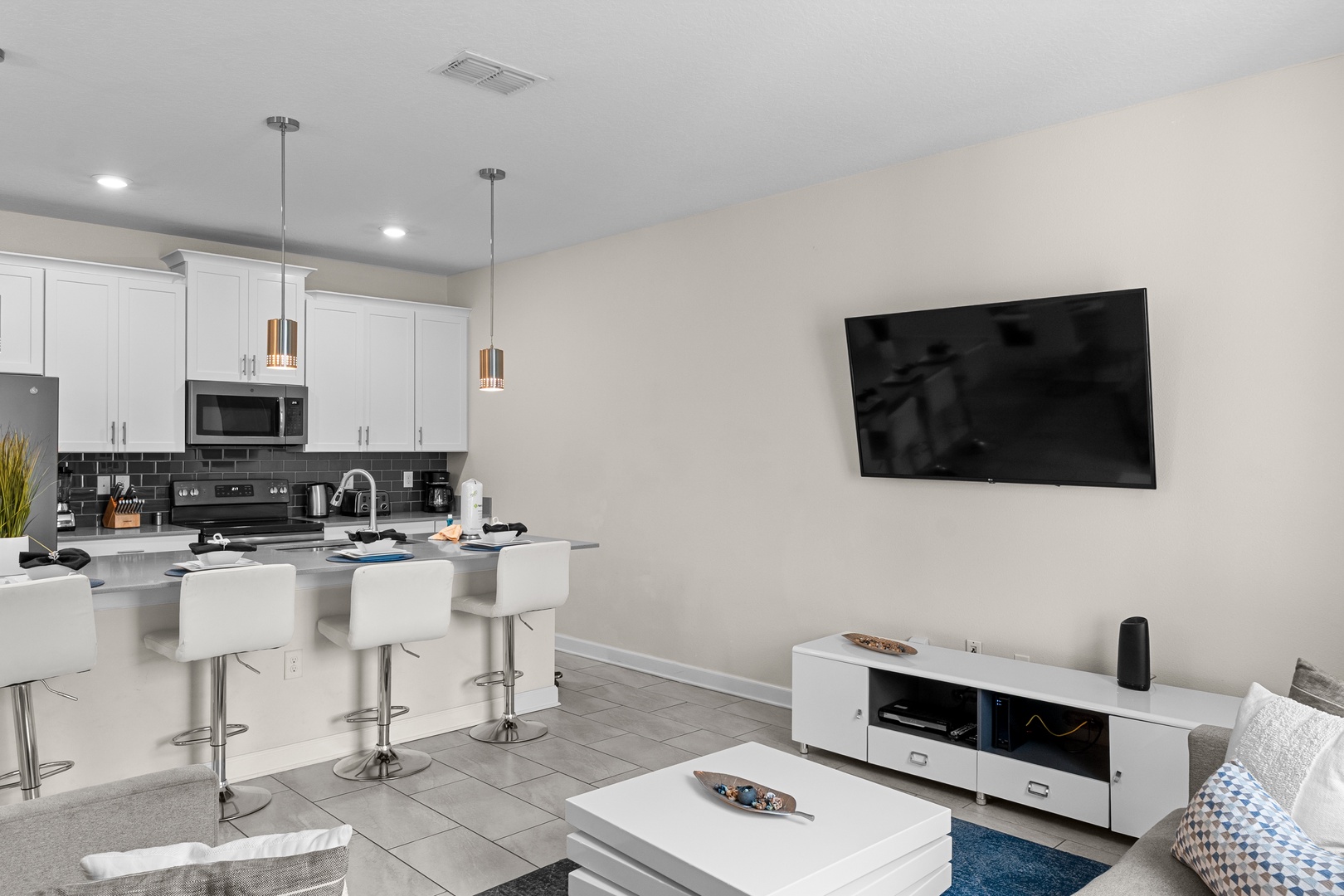 Settle into your sleek open-concept living space where modern kitchen meets cozy lounge—perfect for cooking together and unwinding with evening entertainment.