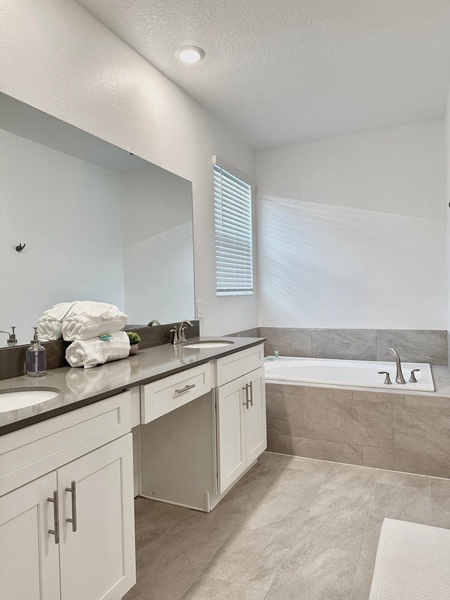 Unwind in your spacious bathroom with a soaking tub, double vanities, and fluffy towels waiting for you.