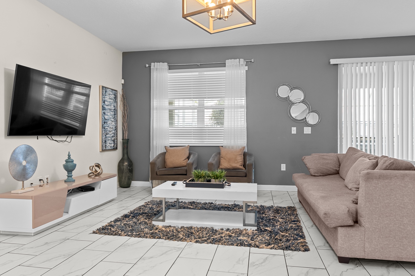 Sink into plush sectional seating while watching your favorite shows on the wall-mounted TV in this stylish living space.