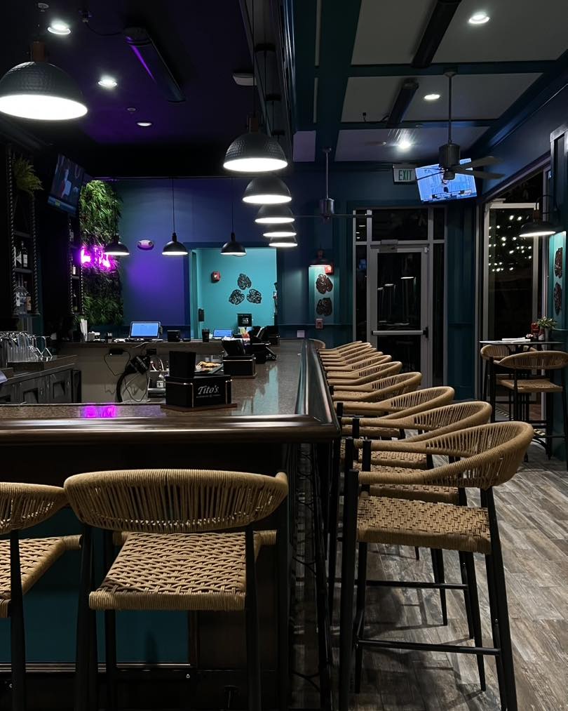 Settle into stylish wicker bar stools at the sleek counter where you'll enjoy crafted drinks in this vibrant lounge space.