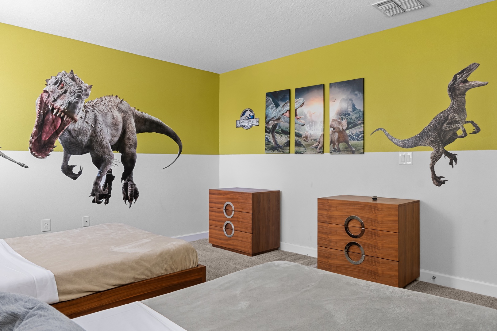 Your kids will roar with delight in this dinosaur-themed bedroom, featuring life-size wall decals and twin beds for adventurous dreams.