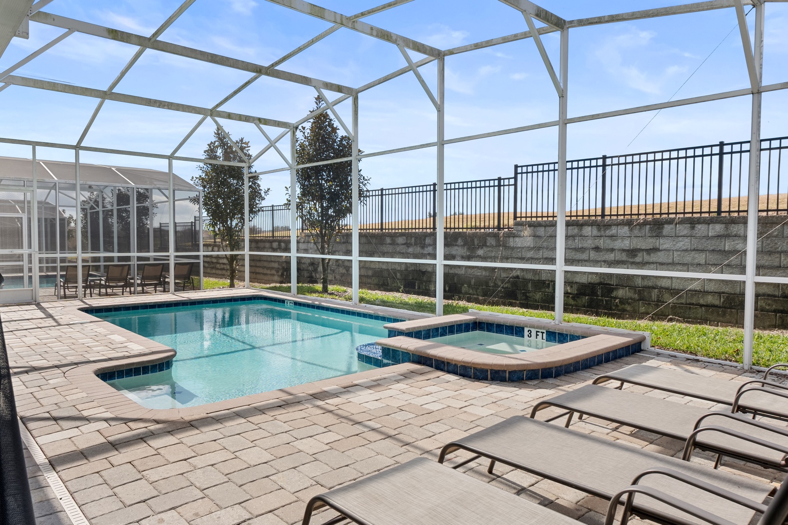 Relax in your private screened pool area with heated spa, perfect for year-round enjoyment under Florida's sunny skies.