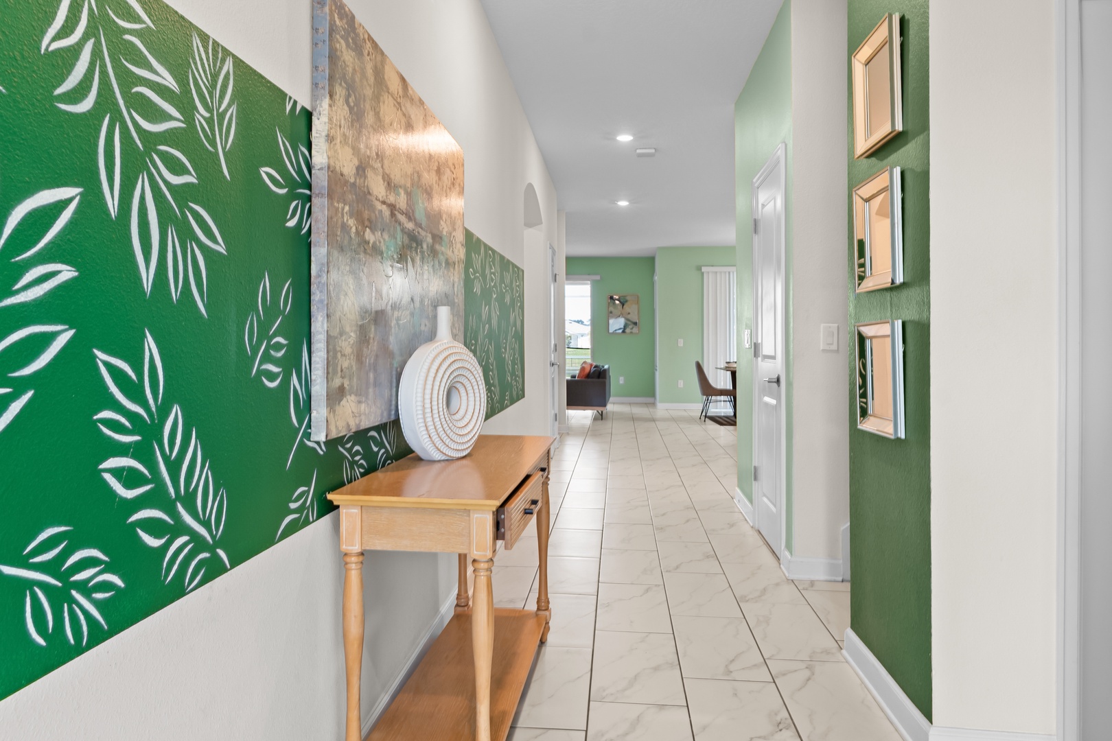 Step into your stylish retreat where botanical wallpaper and warm wood accents create a welcoming atmosphere throughout the bright, open hallway.