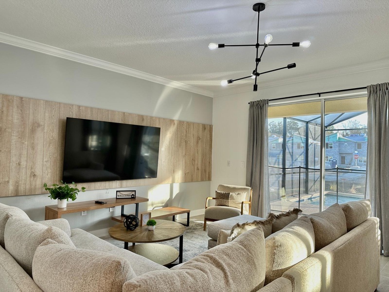 Sink into plush sectional seating while enjoying your favorite shows on the large screen TV in this bright, modern living space.