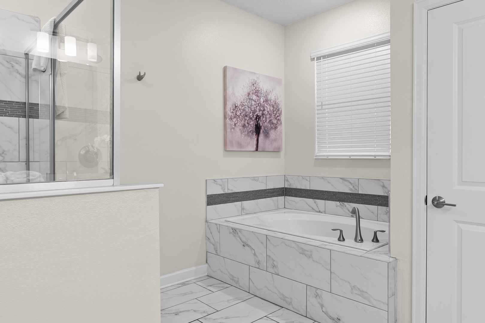 Your spa-like bathroom features elegant marble finishes and a relaxing soaking tub where you can unwind after your adventures.