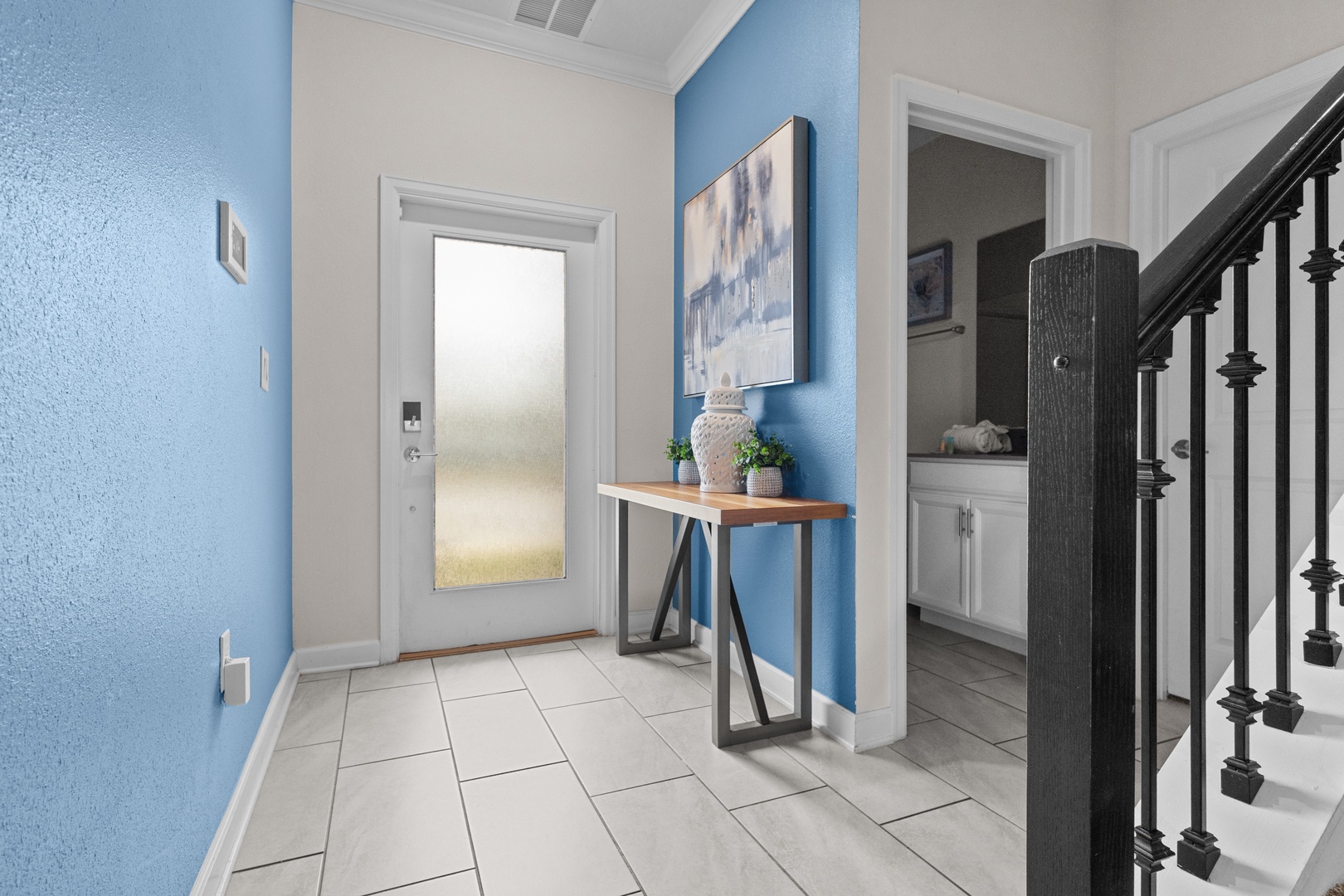 Step into your welcoming entryway where soothing blue walls and elegant decor create the perfect first impression of your home away from home.