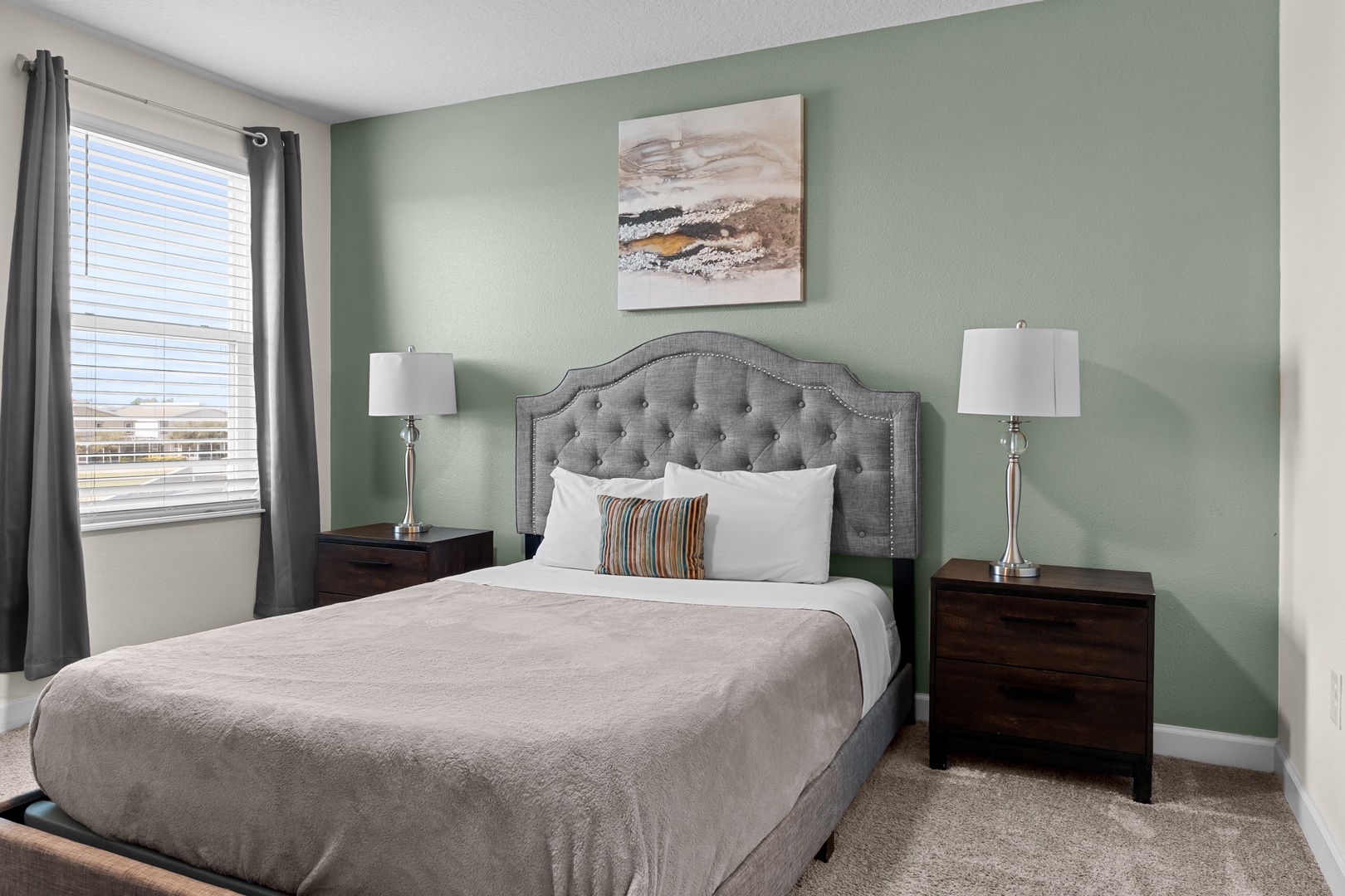 Drift off to sleep in your elegant bedroom, where soft sage walls and plush bedding create the perfect sanctuary for rest.