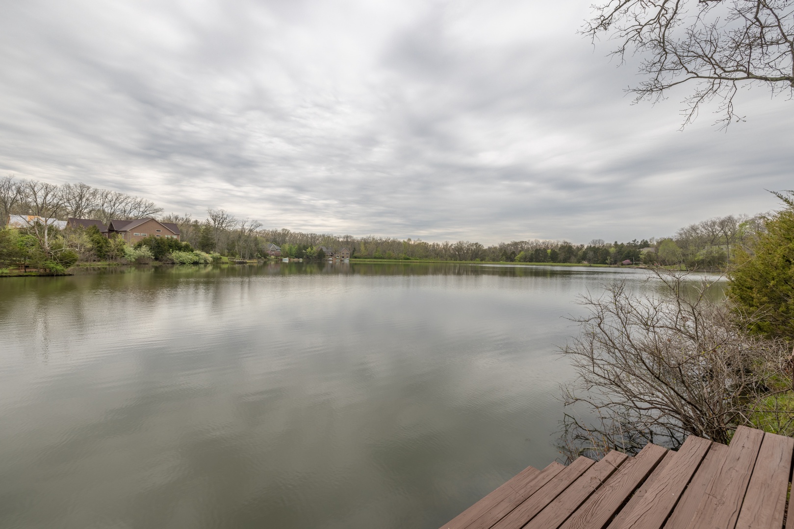 This beautiful custom home is perched on the shores of Lake Charrette