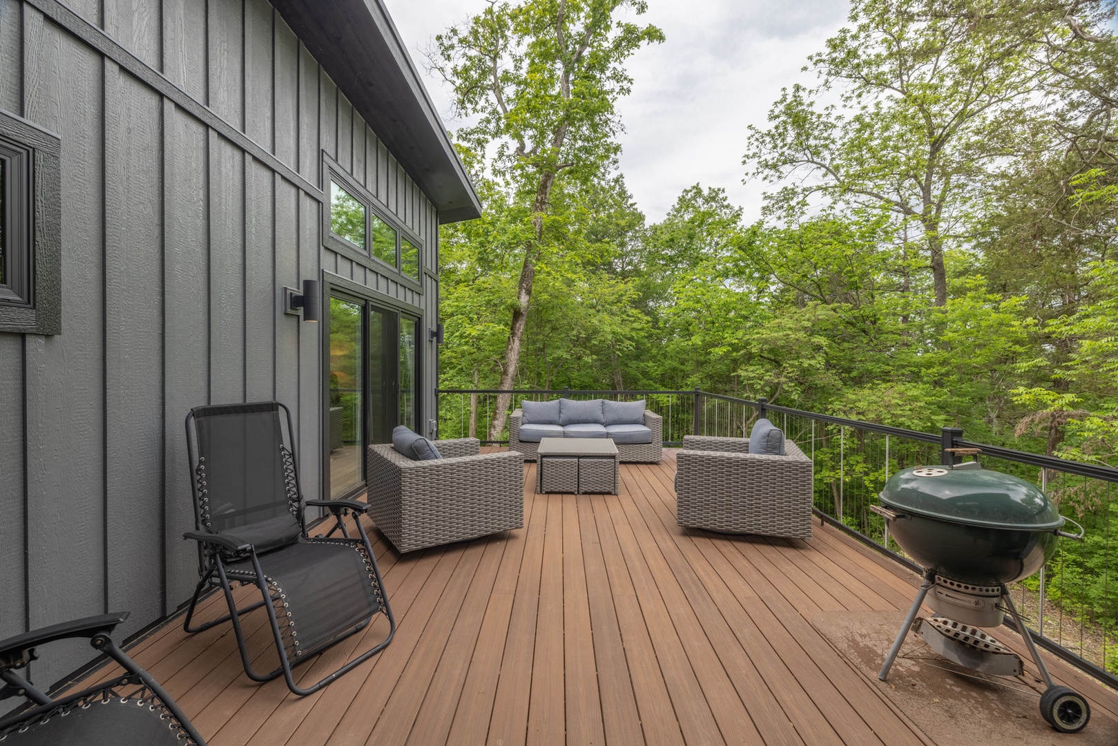 Enjoy nature views from the spacious deck with ample patio seating and a charcoal grill